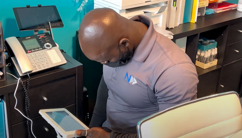 10 Ways Your Last Mile Partner Can Ensure Your Fiber Project’s Success A National OnDemand cable technician measures signal readings at a customer's business.