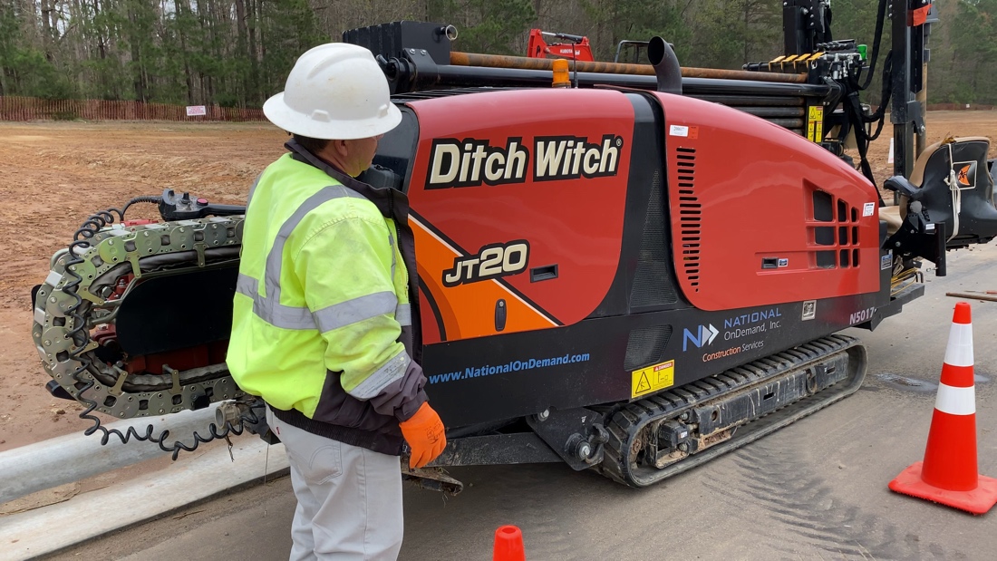 Broadband Networks Accelerate Internet Speeds and Quality of Life A National OnDemand operator standing beside a multi-directional drill