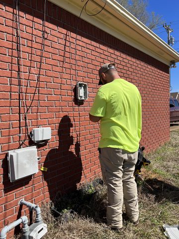A fiber technician sets up a customer with fiber cable. A fiber technician sets up a customer with fiber cable.
