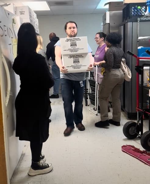 National OnDemand partners with Salvation Army, Second Harvest Food Bank to help feed the hungry Brian Goodlett carries some boxes at the Salvation Army food packing event.